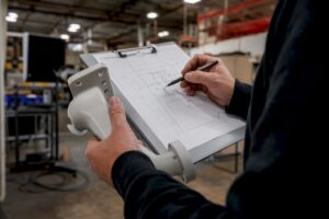Technician reviewing security camera installation plan
